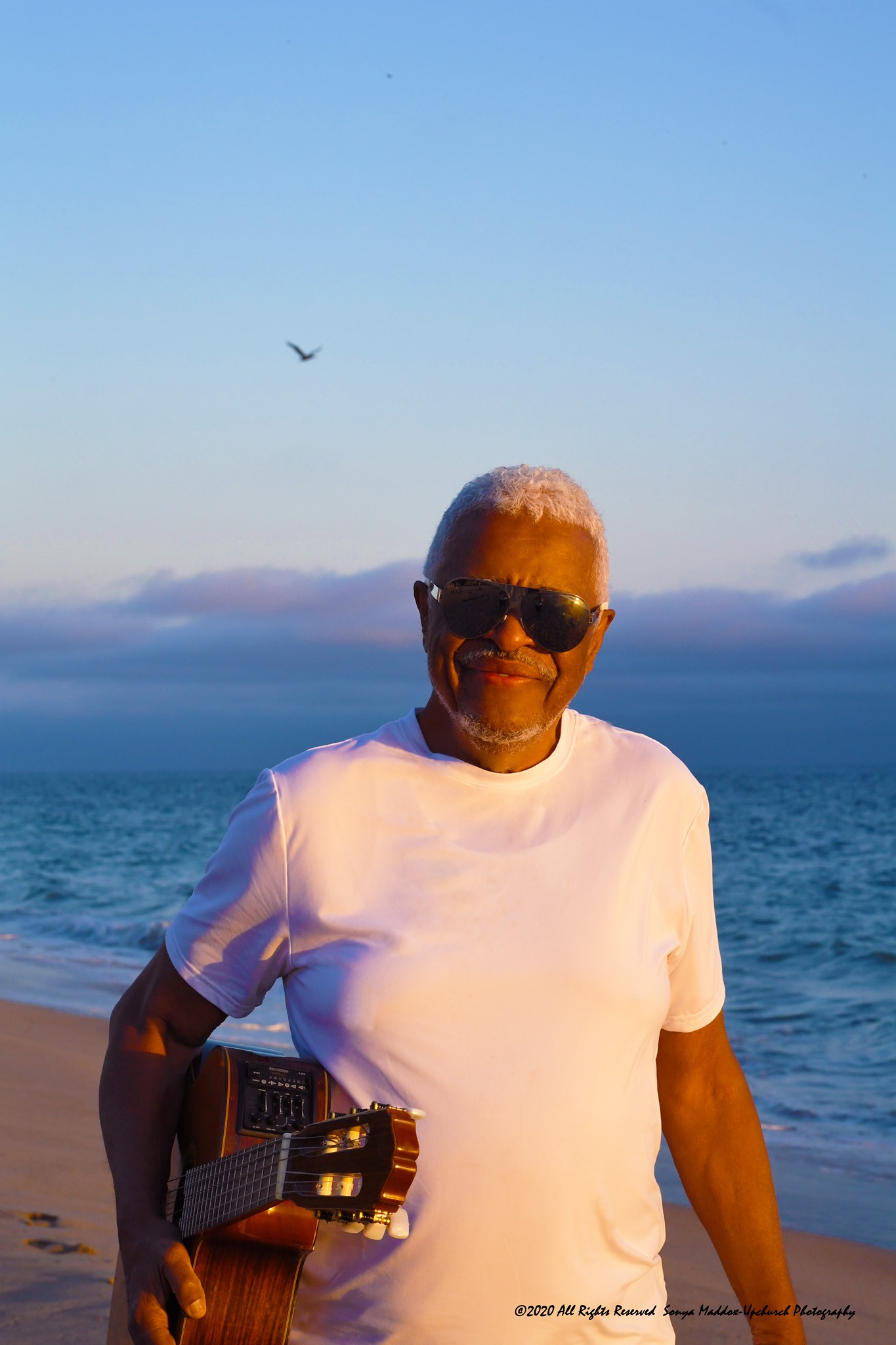Phil Upchurch on the beach with guitar